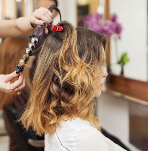 Stylist creating perfect curls at a chic salon